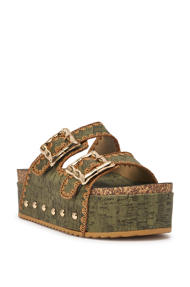 The AZALEA WANG OHKAY GREEN FLATFORM STUD EMBELLISHED SLIP ON SANDAL features olive green faux leather with two wide gold-buckled straps, stud accents, cork-style sole, tan stitching, and a textured finish for stylish comfort. 4