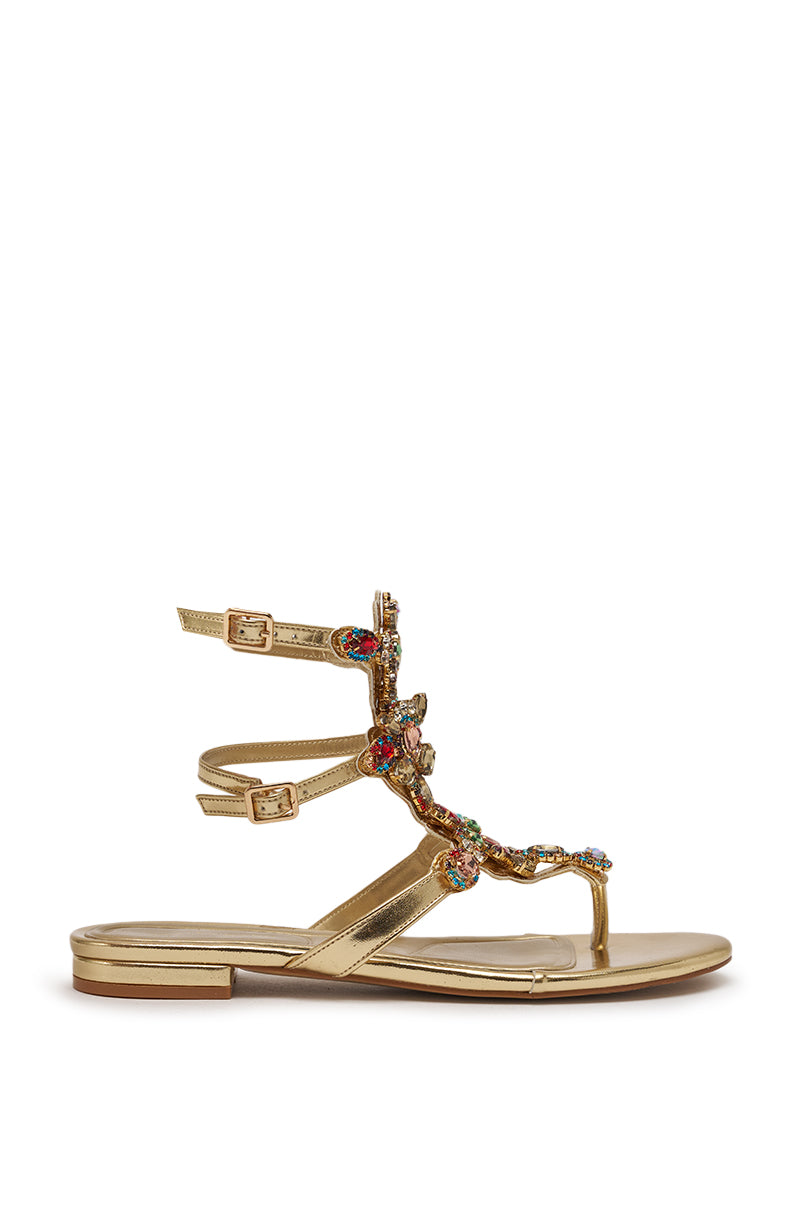 The AZALEA WANG OLISA Gold Rhinestone Embellished Flat Sandal features two ankle straps with colorful jeweled accents, shown against a white background. 4