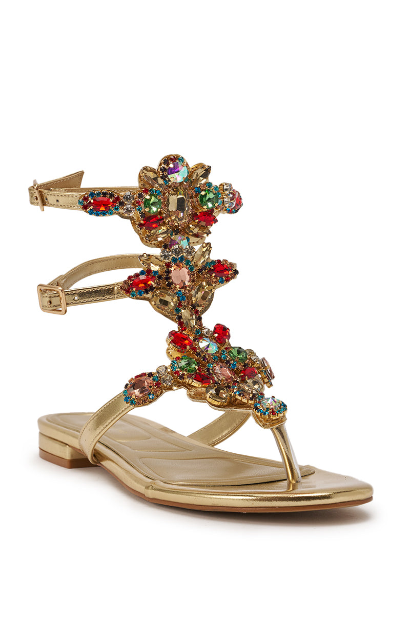 The AZALEA WANG OLISA Gold Rhinestone Embellished Flat Sandal features ankle straps and multicolored crystal clusters for a bold, decorative look. 5