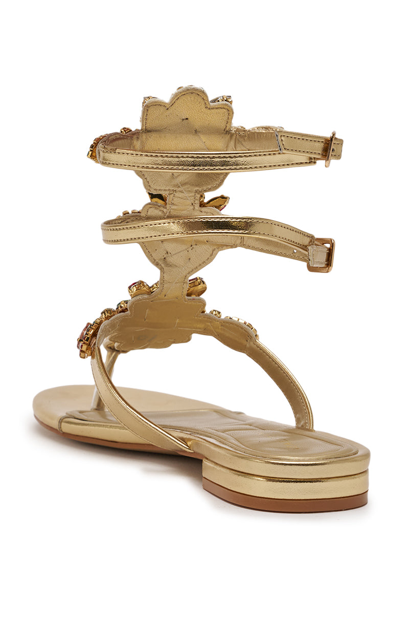 The AZALEA WANG OLISA Gold Rhinestone Embellished Flat Sandal features a jewel-cluster floral ankle strap and cushioned sole, shown from the back. 6
