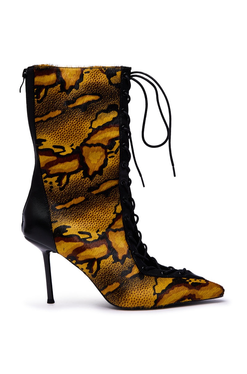 The AZALEA WANG OLIVERS YELLOW STILETTO LACE UP BOOTIE features a striking yellow and black animal print pony hair texture, pointed toe, and black stiletto heel, showcasing bold design and detailed craftsmanship from the side view.