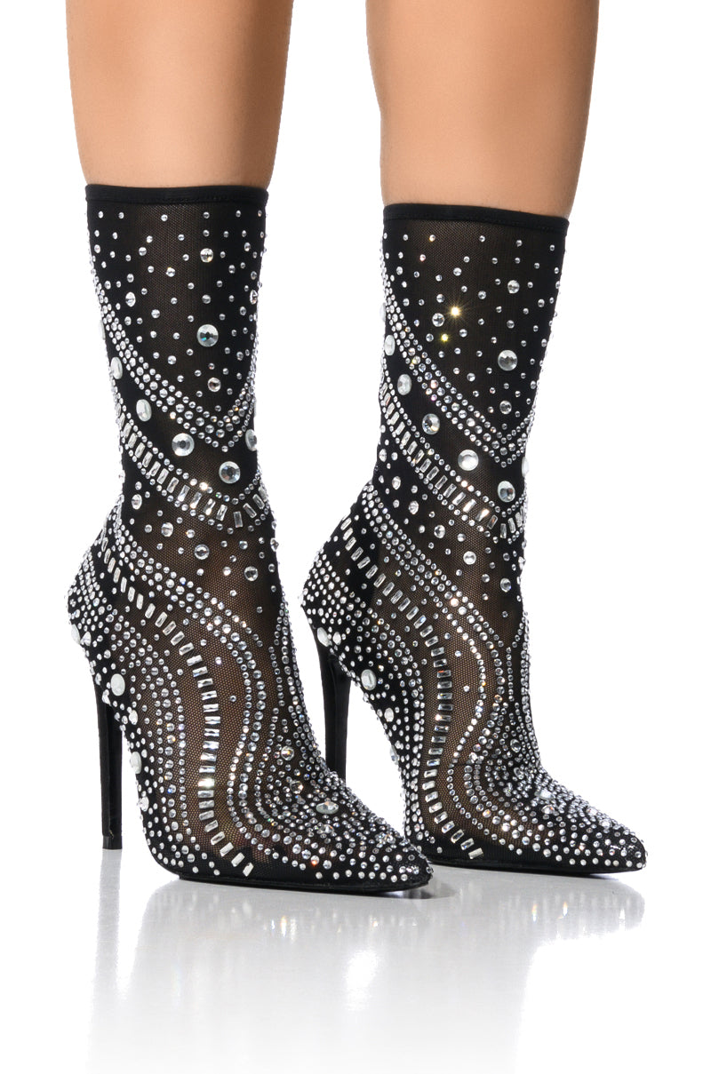 The AZALEA WANG OPRY Black Embellished Mesh Bootie features glamorous stiletto heels and sparkling rhinestones in swirling patterns. Its pointed toes and elegant design stand out stylishly against a plain white background. 3