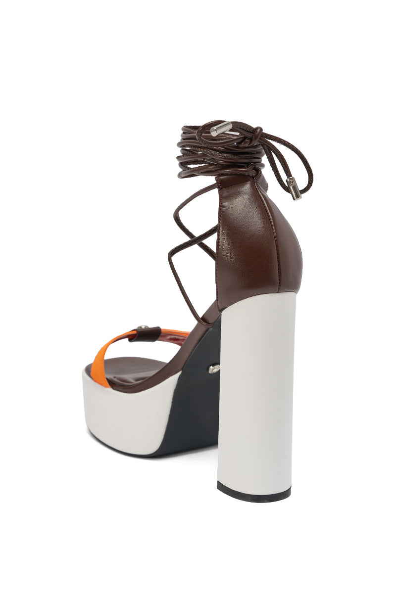 The AKIRA GOLD OREA ORANGE MULTI COLORBLOCKED PLATFORM SANDAL boasts a thick white block heel, brown leather ankle tie-up, and an orange front strap for bold, modern style. 5