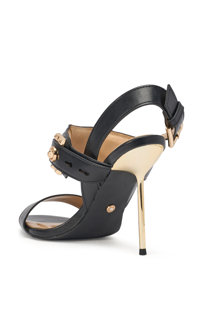 The AZALEA WANG OREL BLACK HARDWARE EMBELLISHED STILETTO SANDAL is a black faux leather sandal with studded details, gold stiletto heel, ankle strap with gold buckle, and chic gold hardware. Shown from back and side views. 5