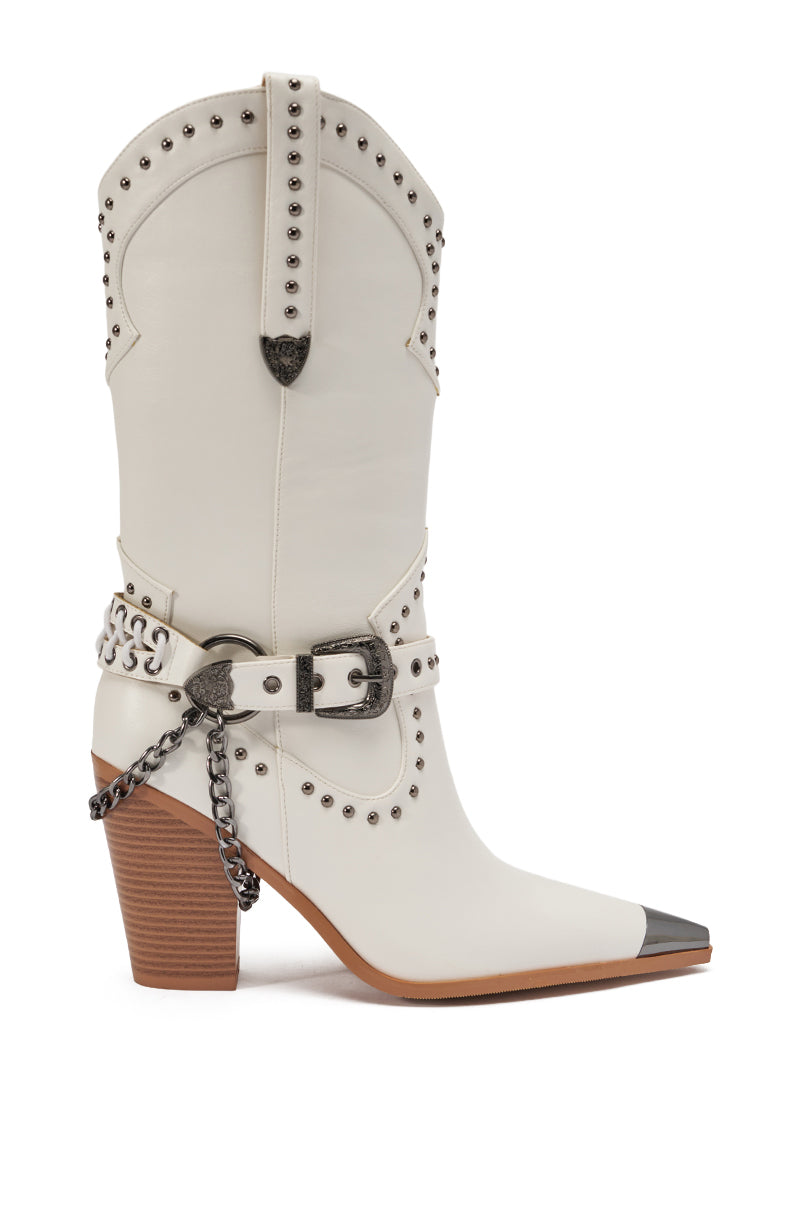 The AZALEA WANG OSBORN WHITE WESTERN BOOTIE features white faux leather, silver studs, a pointed toe with metallic tip, chunky stacked heel, decorative buckle, chain detail, and a tan sole for a stylish mid-calf cowboy look.