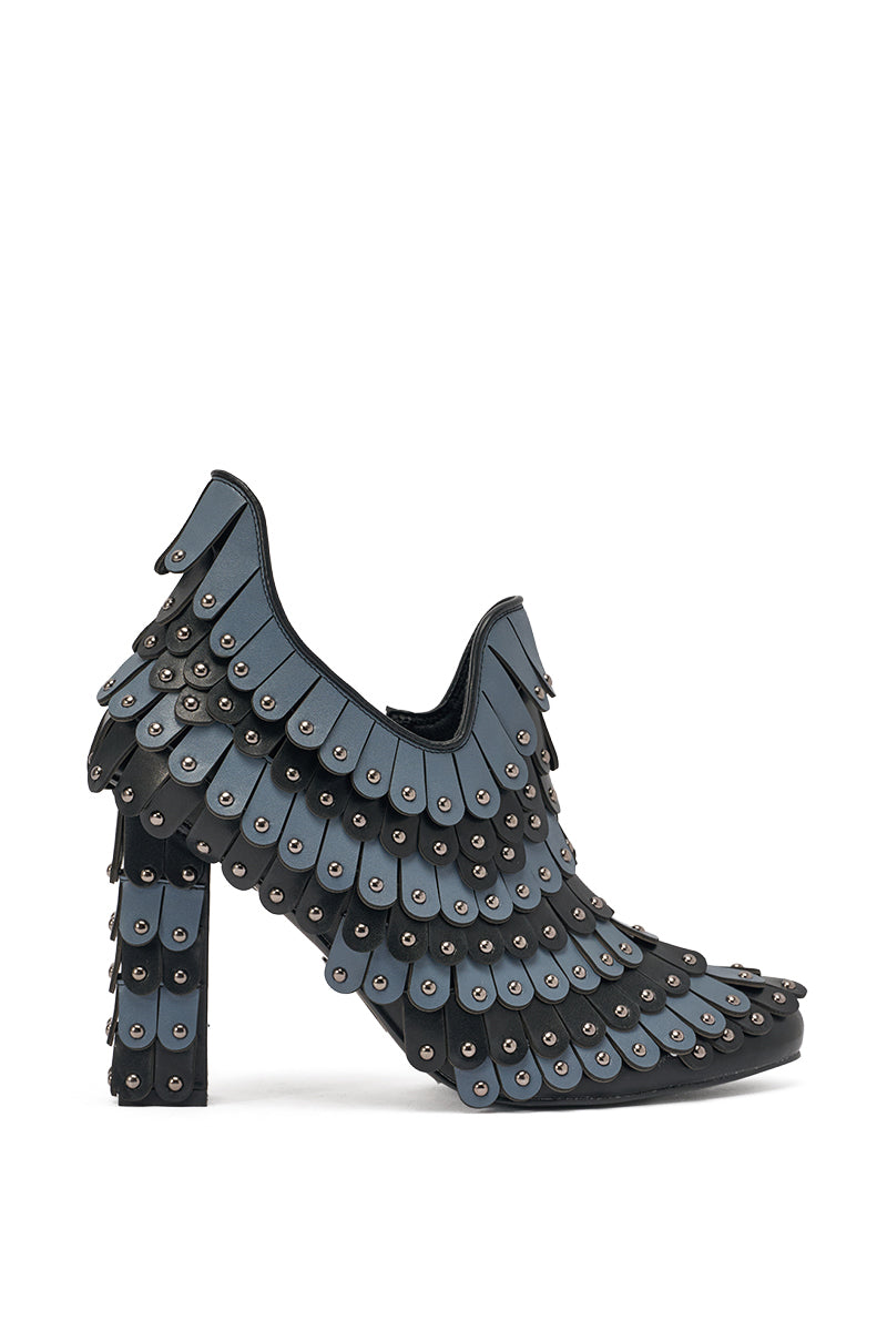 The AKIRA GOLD OSTENTATION BLACK ABSTRACT PUMP features layered blue and black faux leather panels with metallic studs, creating a bold, textured look. Both the high heel and upper are fully adorned in this striking, scale-inspired design. 4