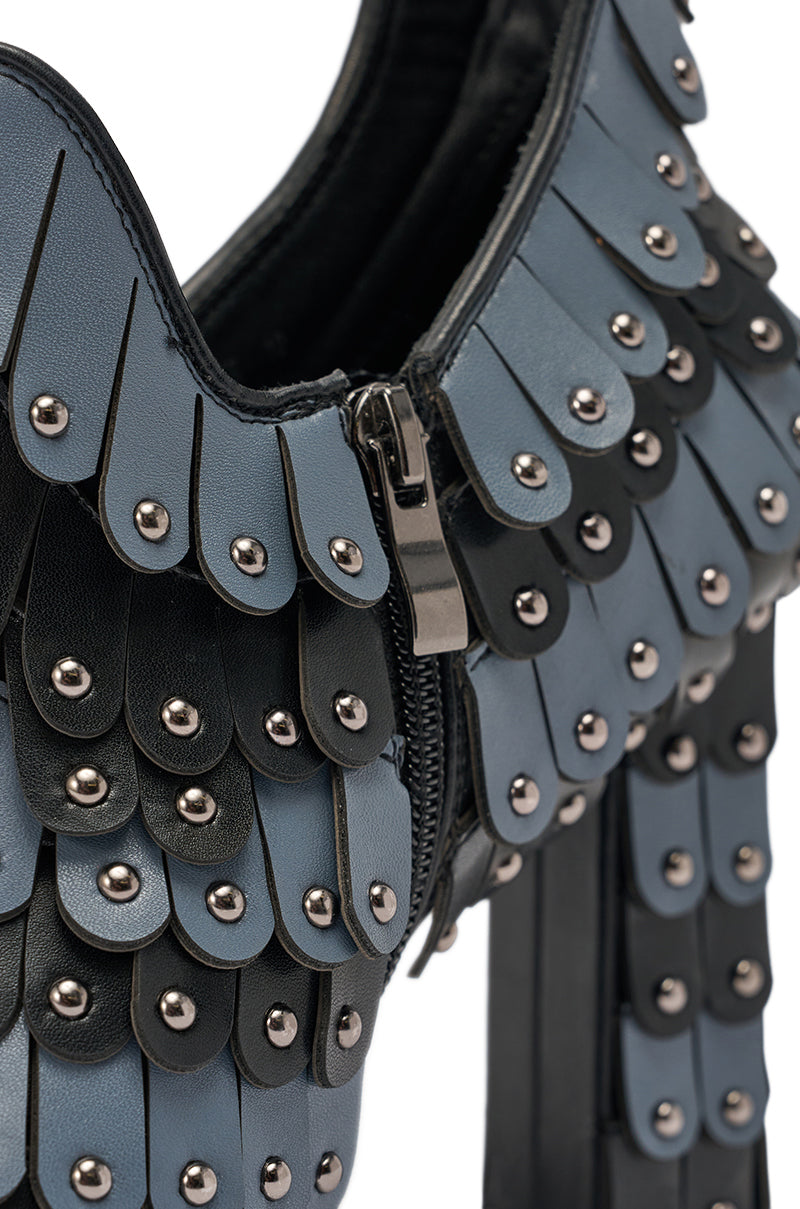 Close-up of the AKIRA GOLD OSTENTATION BLACK ABSTRACT PUMP featuring an almond toe, high heel, blue and black leather scales with metallic studs, and a visible side zipper. 6