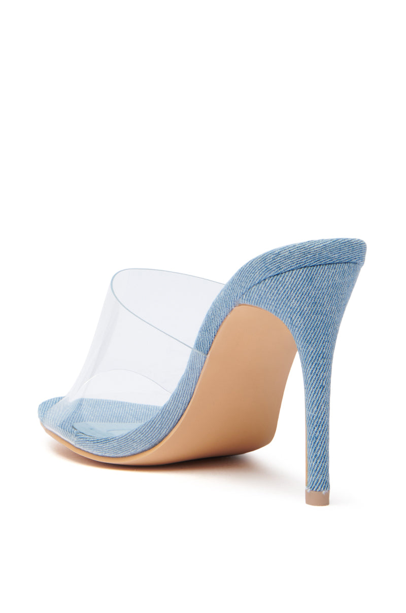 The AKIRA OSWEGO DENIM NEW SLIP ON MULE SANDAL showcases a stylish high-heeled mule with a denim-textured platform and heel. Its clear upper offers a modern touch, ensuring Slip On Fit for easy wear, while the Comfort Cushion Insole combines casual chic with elegance.