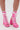 A person wears the AZALEA WANG PAMINA PINK OPEN TOE SPORTY BOOTIE—bright pink, chunky-heeled, with white laces and faux leather stripes. The open-toe boots rise above the ankles and are displayed against a plain background.