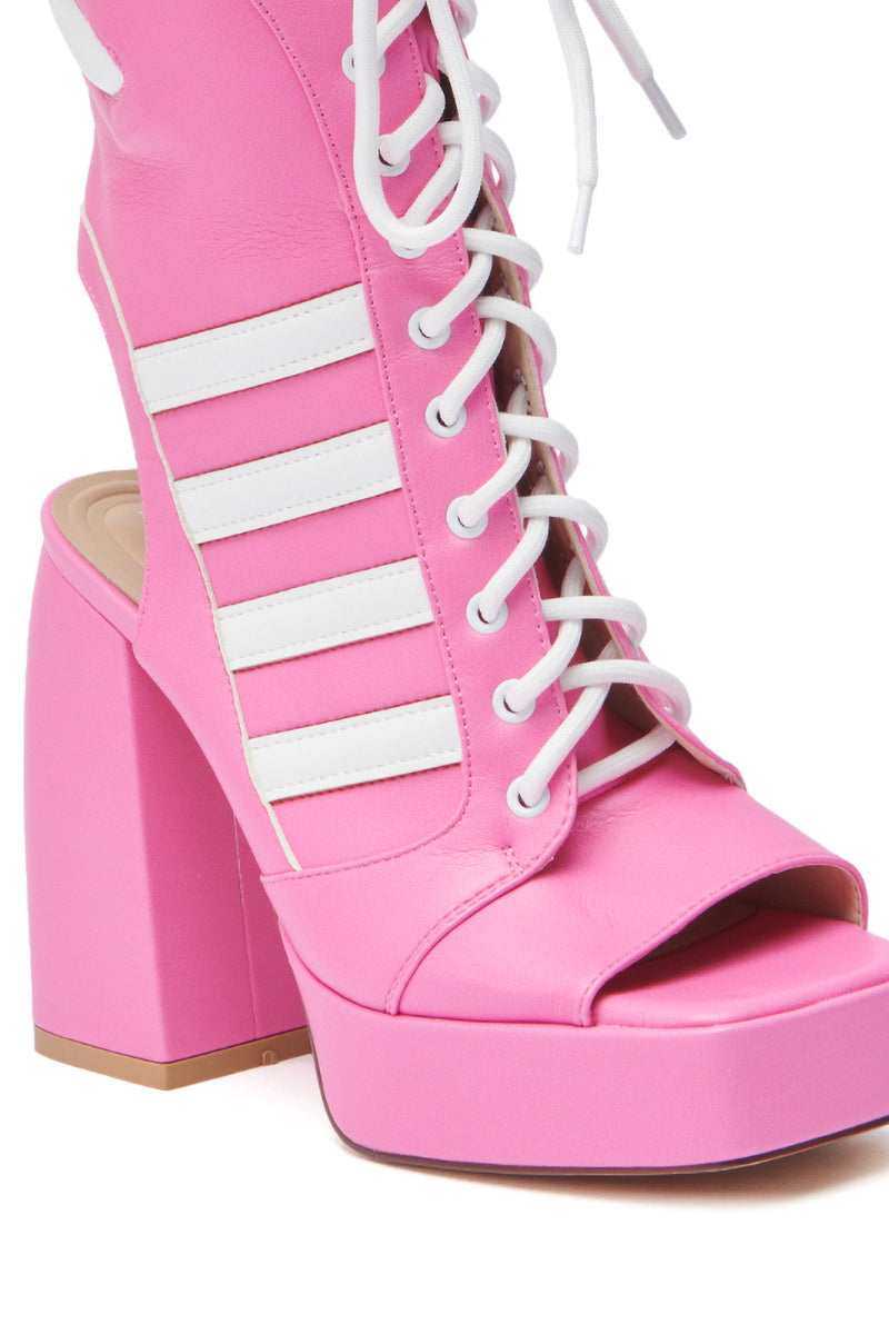 A close-up of the AZALEA WANG PAMINA PINK OPEN TOE SPORTY BOOTIE in faux leather with white laces, sporty-chic side straps, and a chunky open toe platform heel. 6