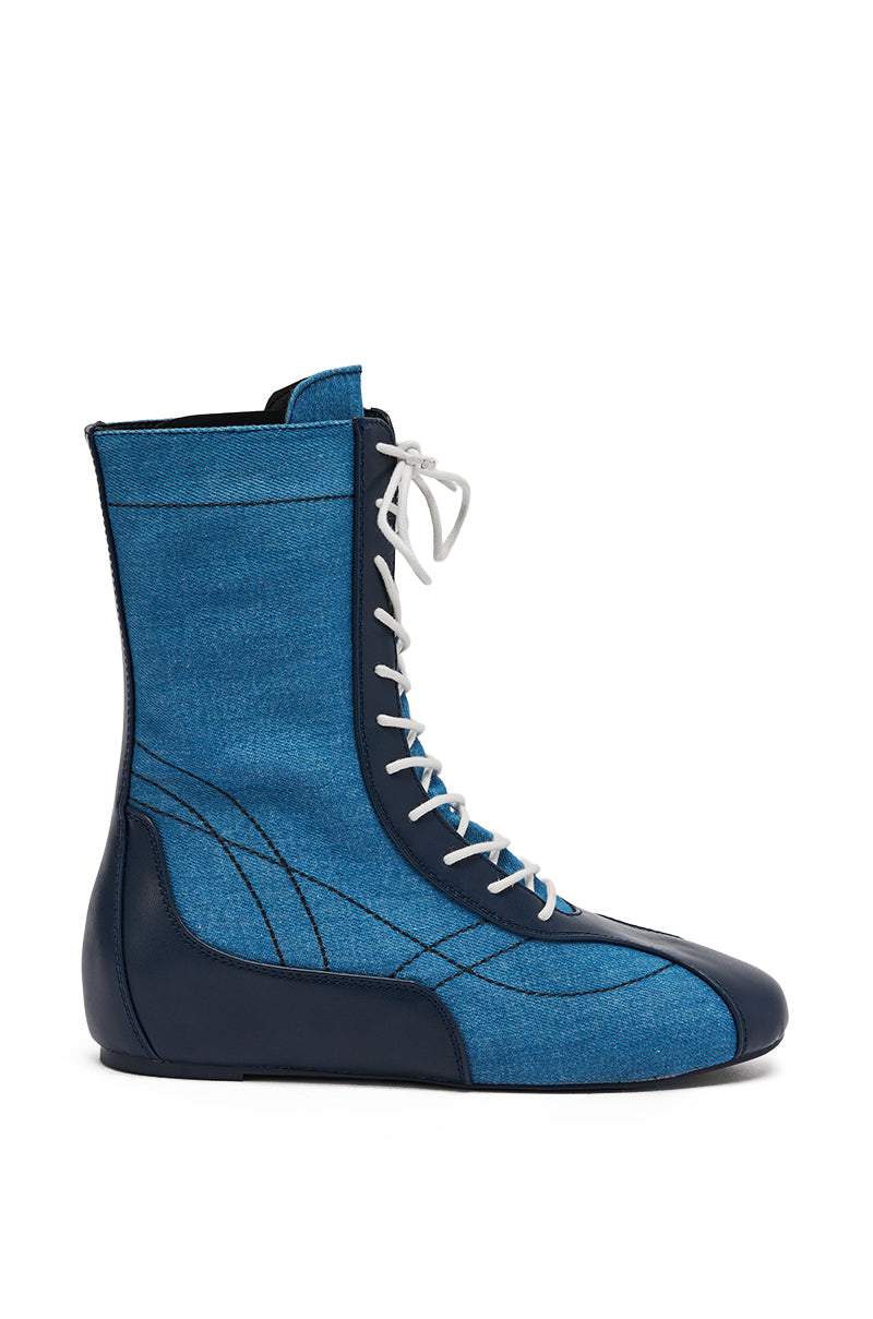 The AZALEA WANG PASSER NAVY FLAT SNEAKER is a blue and black mid-calf shoe that updates the classic denim sneaker with modern style.