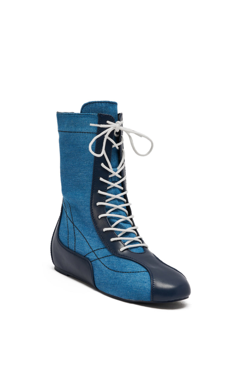 The AZALEA WANG PASSER NAVY FLAT SNEAKER is a high-top with blue denim fabric, dark blue leather accents, white stitching, and white laces, shown against a plain white background.