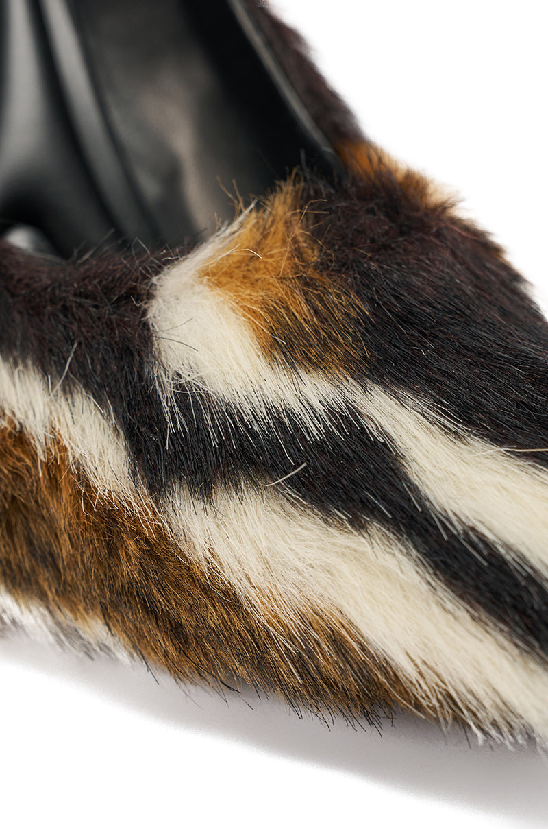 Close-up of the AZALEA WANG PAULHINO FAUX FUR PUMP’s pointed toe, featuring a striped pattern in multicolored shades of brown, black, and white. 5