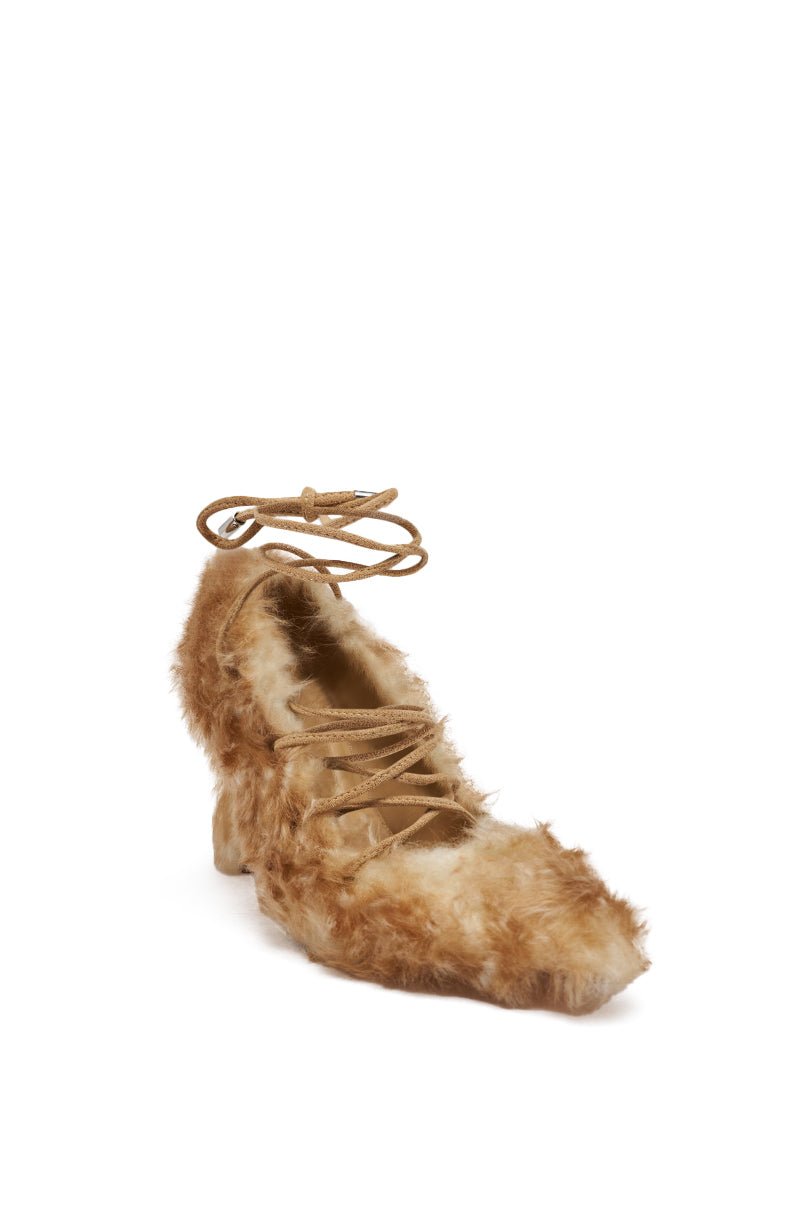 The AZALEA WANG PAULHINO SNOW LEOPARD STRAPPY PUMP is a chic stiletto heel featuring brown faux fur, tan laces, and an ankle wrap tie, displayed against a white background.