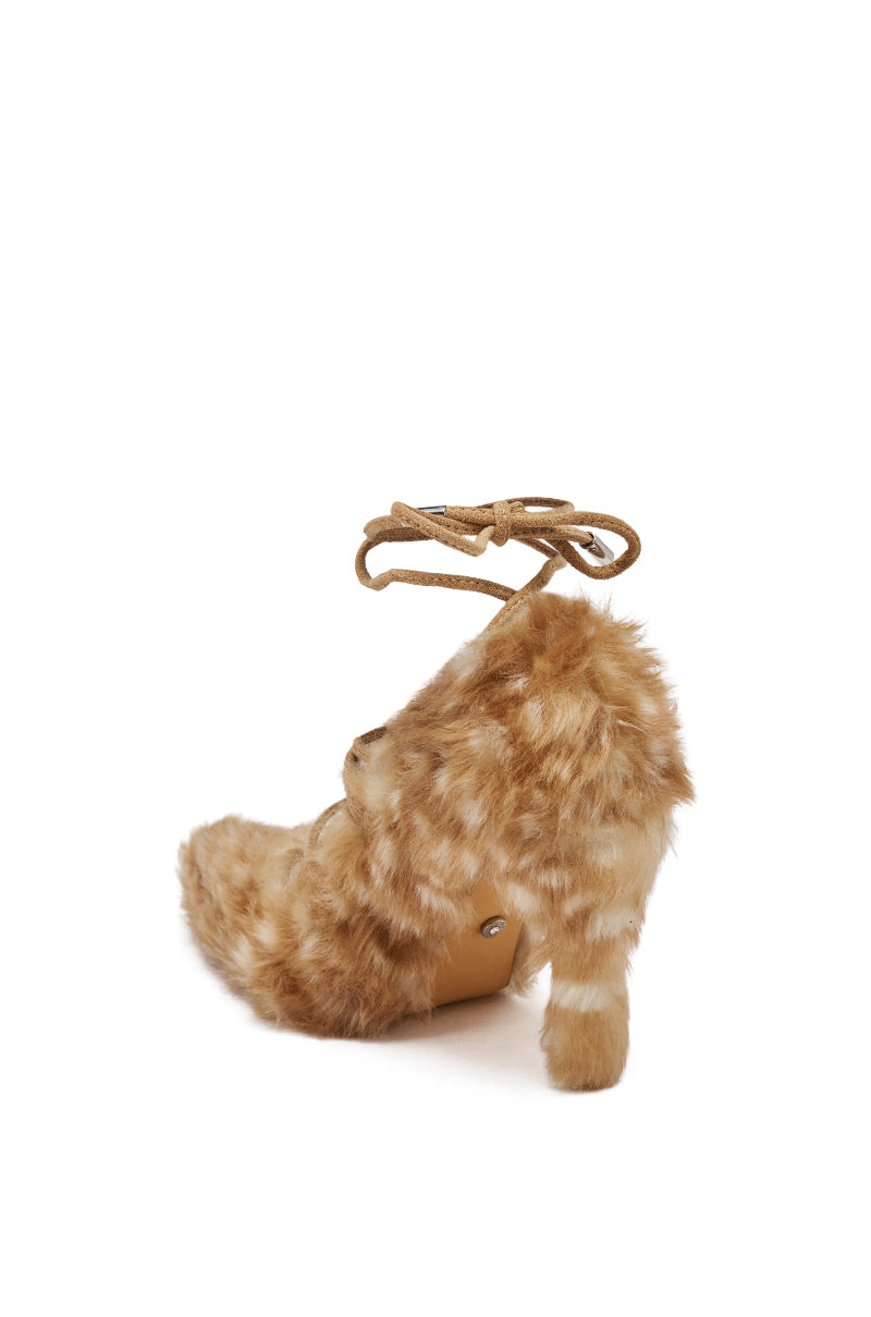 The AZALEA WANG PAULHINO SNOW LEOPARD STRAPPY PUMP is a high-heeled stiletto shoe with light brown faux fur and a lace-up ankle strap, showcased against a simple white background.