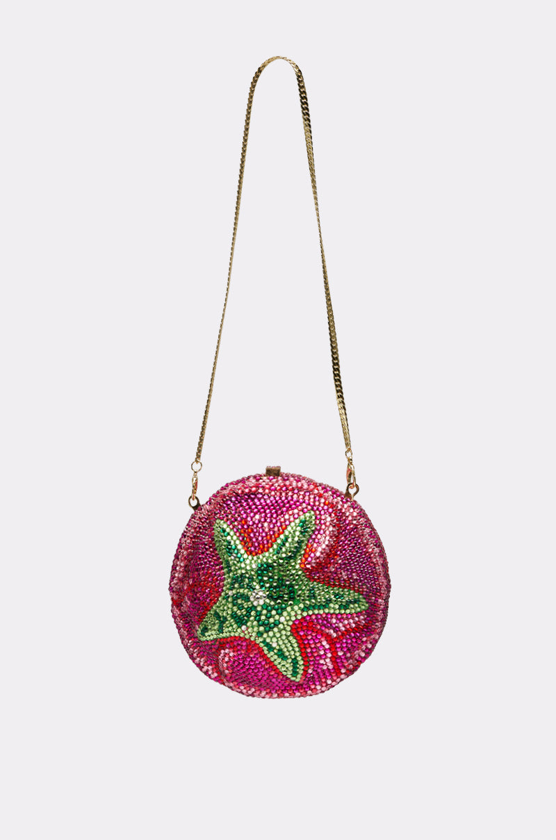 The NOT THAT KIND OF ROSE PURSE is a round hardshell handbag with a gold chain strap, featuring pink and red crystals and a green crystal tomato design on the front, shown against a plain light background.