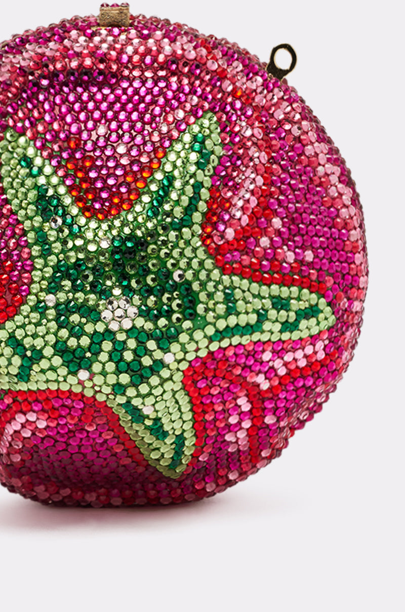 The NOT THAT KIND OF ROSE PURSE is a sparkling, round hardshell handbag adorned with pink and red rhinestones and features a large green crystal starfish design on the front.