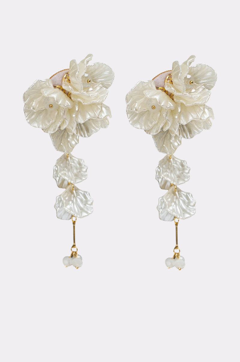 The FOR THE PARTY EARRING is a pair of statement drop earrings with layered ivory floral designs, dangling petals, and small bead accents for an elegant look. 2