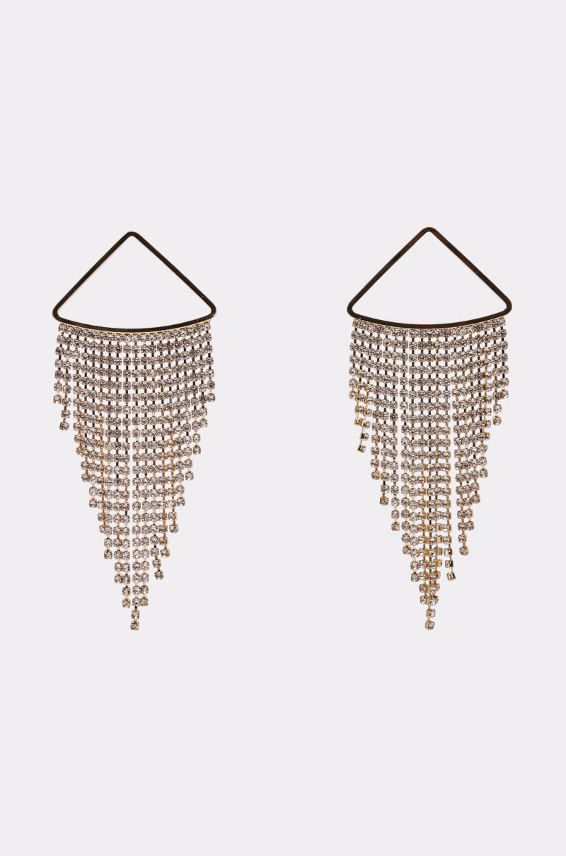 The WE'RE GOING OUT GOLD EARRING features triangular tops with cascading rows of rhinestone fringe in a sparkling V-shape, shown against a plain white background. 0
