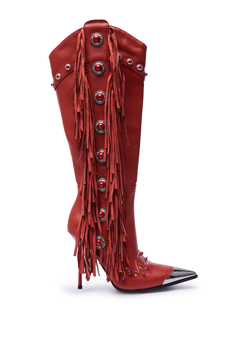 The AZALEA WANG PELAGIANA Red Western Pointed Toe Stiletto Boot is a knee-high faux leather style with a black pointed toe, silver studs, oversized red buttons, and long matching fringe for a bold Western-inspired look. 4