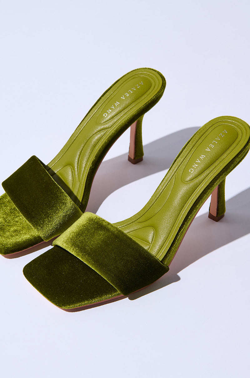 Displayed on a white background, the AZALEA WANG PERSUASION GREEN SANDAL features chic green velvet high-heeled sandals with a stiletto heel and square toes. The luxurious velvet upper adds an elegant touch, while the inner sole prominently displays the brand name.