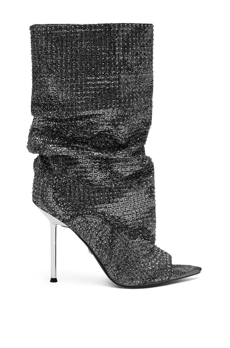 The AZALEA WANG PHOTINE BLACK MULTI SPARKLE OPEN TOE STILETTO BOOTIE is a knee-high, slouchy bootie adorned with black rhinestones, featuring an open toe and a thin metallic stiletto heel.