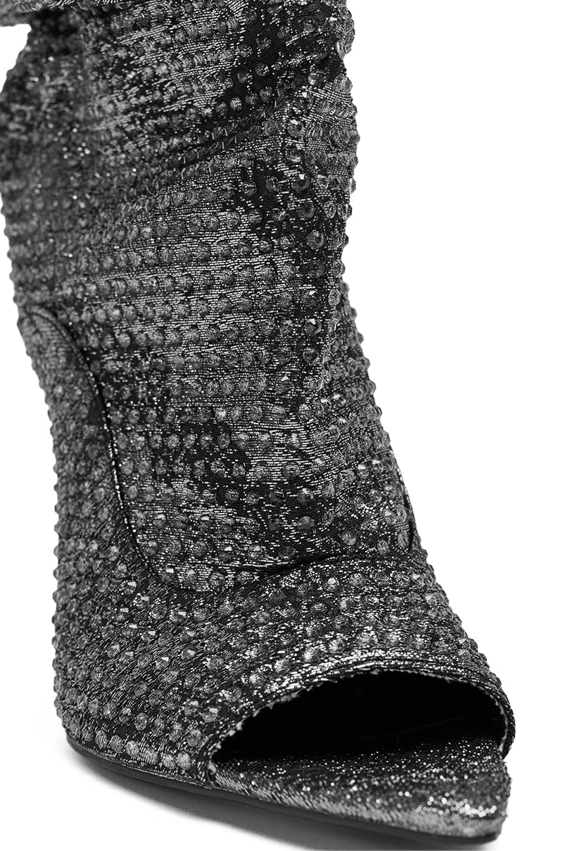 Close-up of the AZALEA WANG PHOTINE Black Multi Sparkle Open Toe Stiletto Bootie, featuring black glittery texture, sparkling details, and intricate material on the front and side.