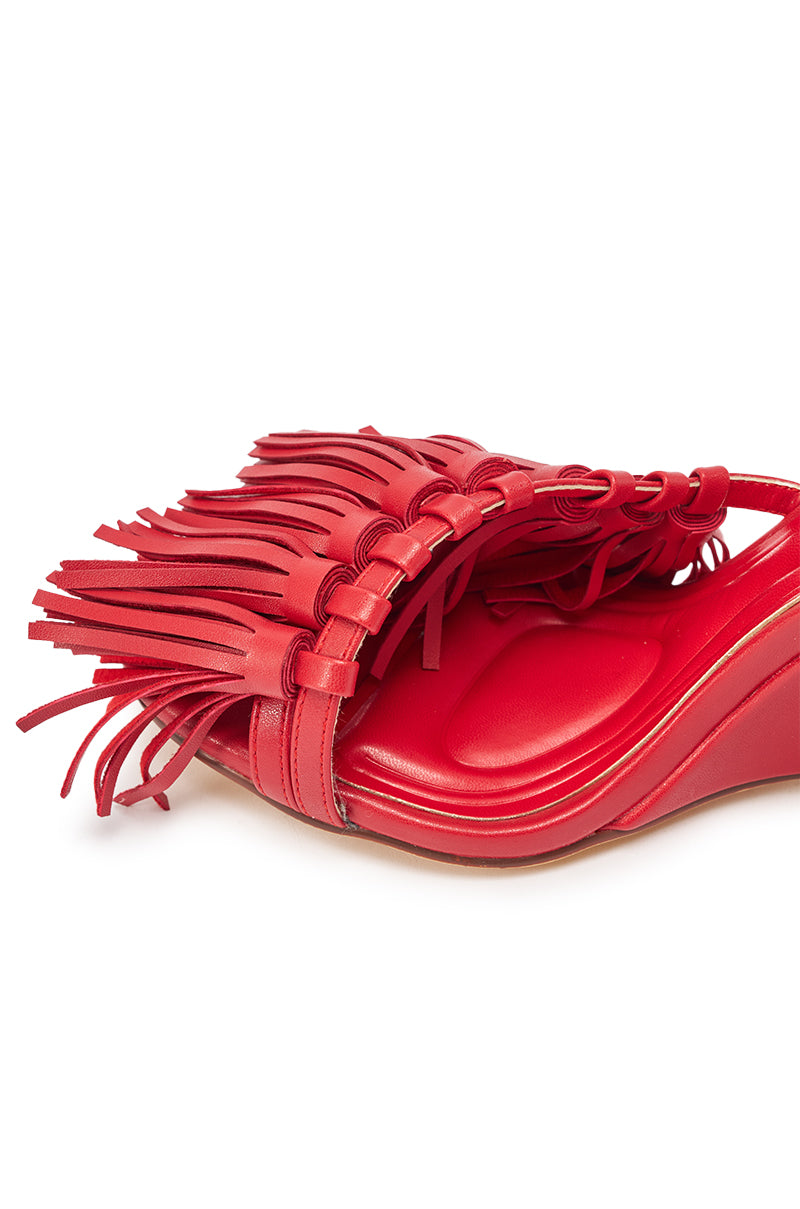 A close-up of the AZALEA WANG PHRIXOS Red Wedge Fringe PU Sandal featuring a cushioned footbed, comfy slingback design, and multiple thin leather strips forming a stylish fringe for a chic, modern look. 6
