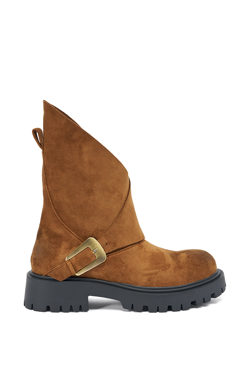 The AZALEA WANG PHRIXUS BROWN CHUNKY SHORT SHAFT FAUX SUEDE BOOT features a brown faux suede finish, asymmetrical flap detail, decorative brass buckle, and a chunky lug sole for a modern look.