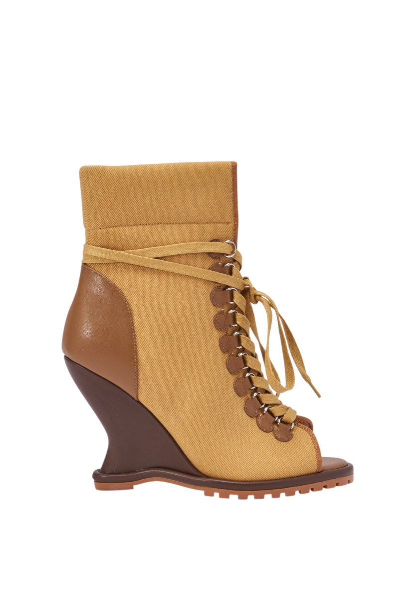 The AZALEA WANG PINGREE BROWN OPEN TOE WEDGE BOOTIE features a tan canvas upper, brown leather accents, lace-up front, peep toe, sculpted dark brown wedge heel, and a modern lug sole for added edge. 3