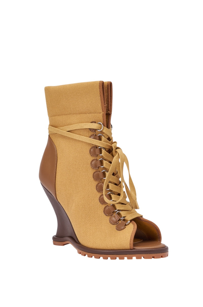The AZALEA WANG PINGREE BROWN OPEN TOE WEDGE BOOTIE features a tan canvas and leather mix, open toe, lace-up front, and rugged sole for a sleek streetwear look. 4