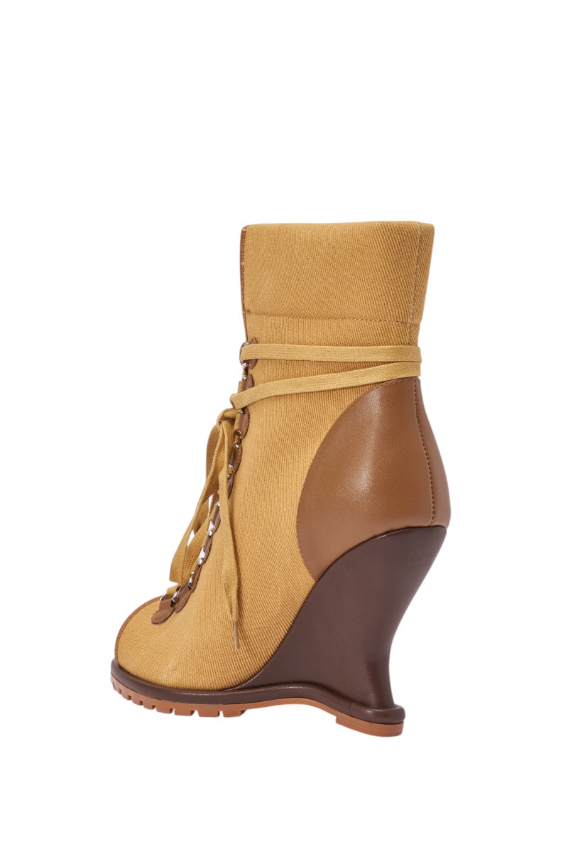 The AZALEA WANG PINGREE BROWN OPEN TOE WEDGE BOOTIE features brown leather accents, an open toe, lace-up front, and a high wedge heel—ideal for streetwear bootie fans and showcased from the side on a white background. 5