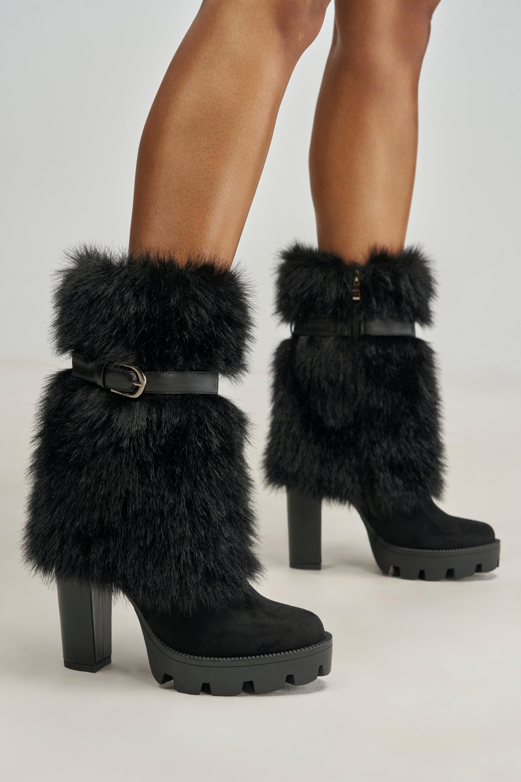 AZALEA WANG PIROSKA BLACK FUR BLOCK BOOTIE in black faux fur with thick block heels, lug soles, and fur trim secured by a buckle strap.