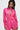 A woman stands against a neutral background wearing the LOOK THIS WAY SHINY BODYSUIT—a hot pink, metallic, long-sleeve romper with a deep V-neck, wide cuffs, belted waist, and choker collar.