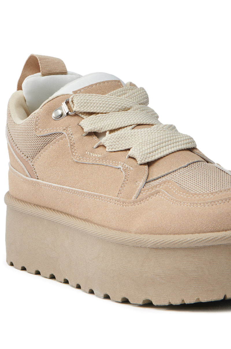 The POPULARITY SAND FLATFORM SNEAKER features a stylish tan suede design with a thick sole and textured pattern. It has cream-colored laces, an almond toe, and is showcased from side and top views to highlight its trendy Slip-On fit. 6