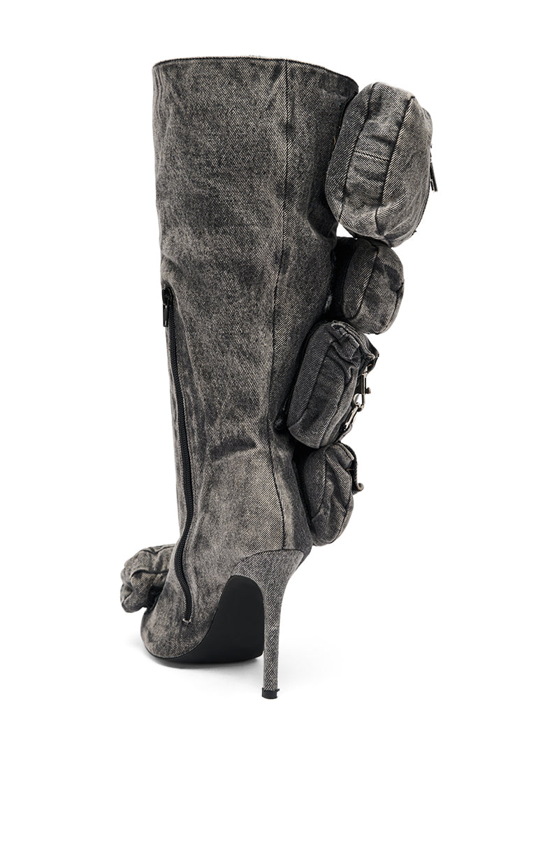 The AZALEA WANG PRAVIN BLACK POCKET DETAIL STILETTO BOOT is a knee-high, high-heeled stiletto boot in black with multiple pouch-like pockets attached along the back. 5