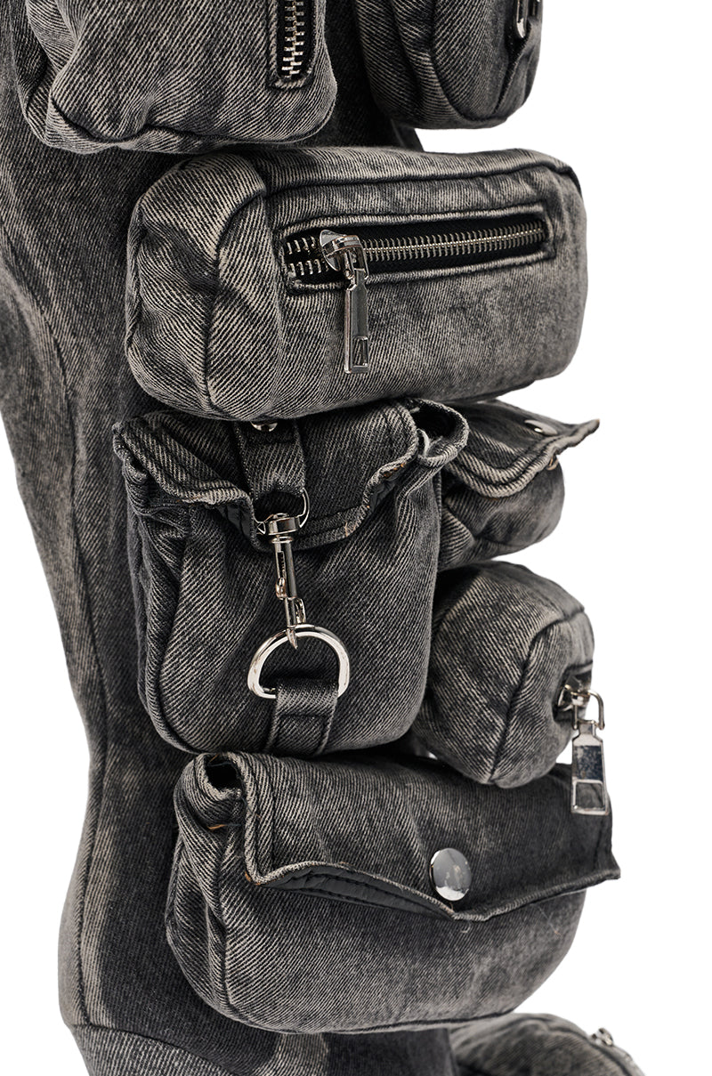 Close-up of gray denim pouches with zippers, buttons, and rings—reminiscent of the pocket detail featured on the AZALEA WANG PRAVIN BLACK POCKET DETAIL STILETTO BOOT. 6