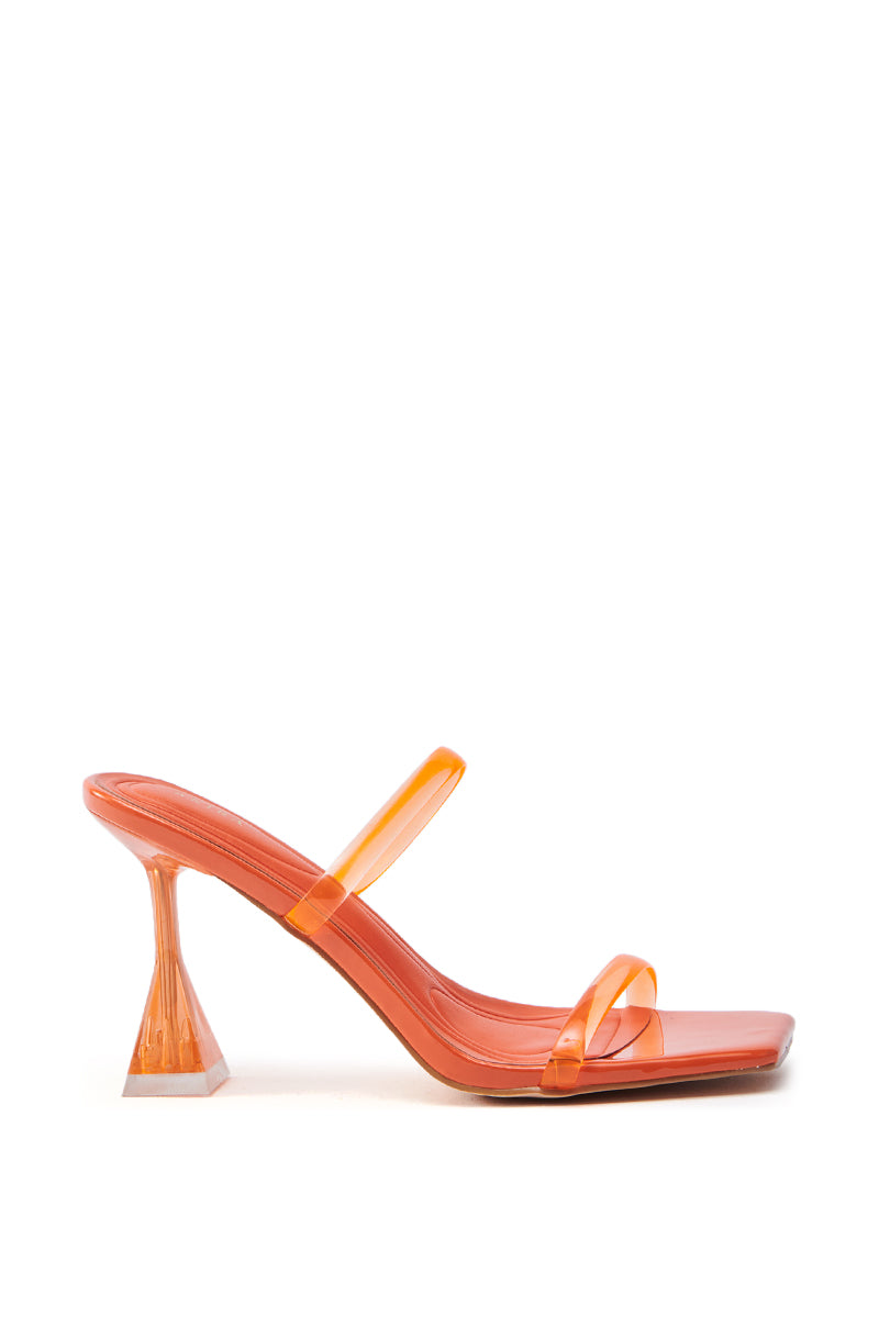 The AZALEA WANG PTAH ORANGE JELLY CHUNKY SLIP ON SANDAL features a flared stiletto heel with a clear, geometric design. It has two transparent straps, a square toe, and a glossy finish set on a contrasting white background.