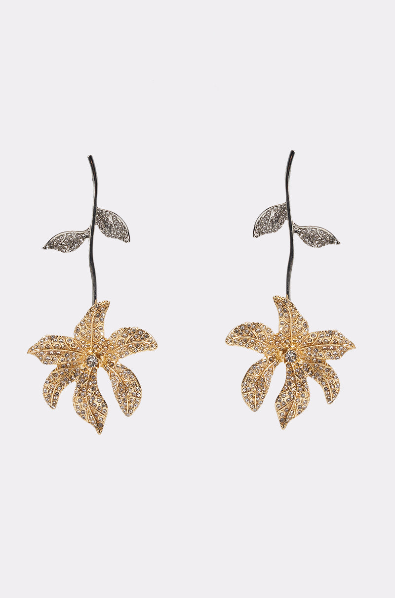 The AT THE GALA EARRING features rhinestone floral drops with detailed petals, leaves, a long black stem, and sparkling accents—perfect statement earrings for wedding guests, shown on a plain white background. 0