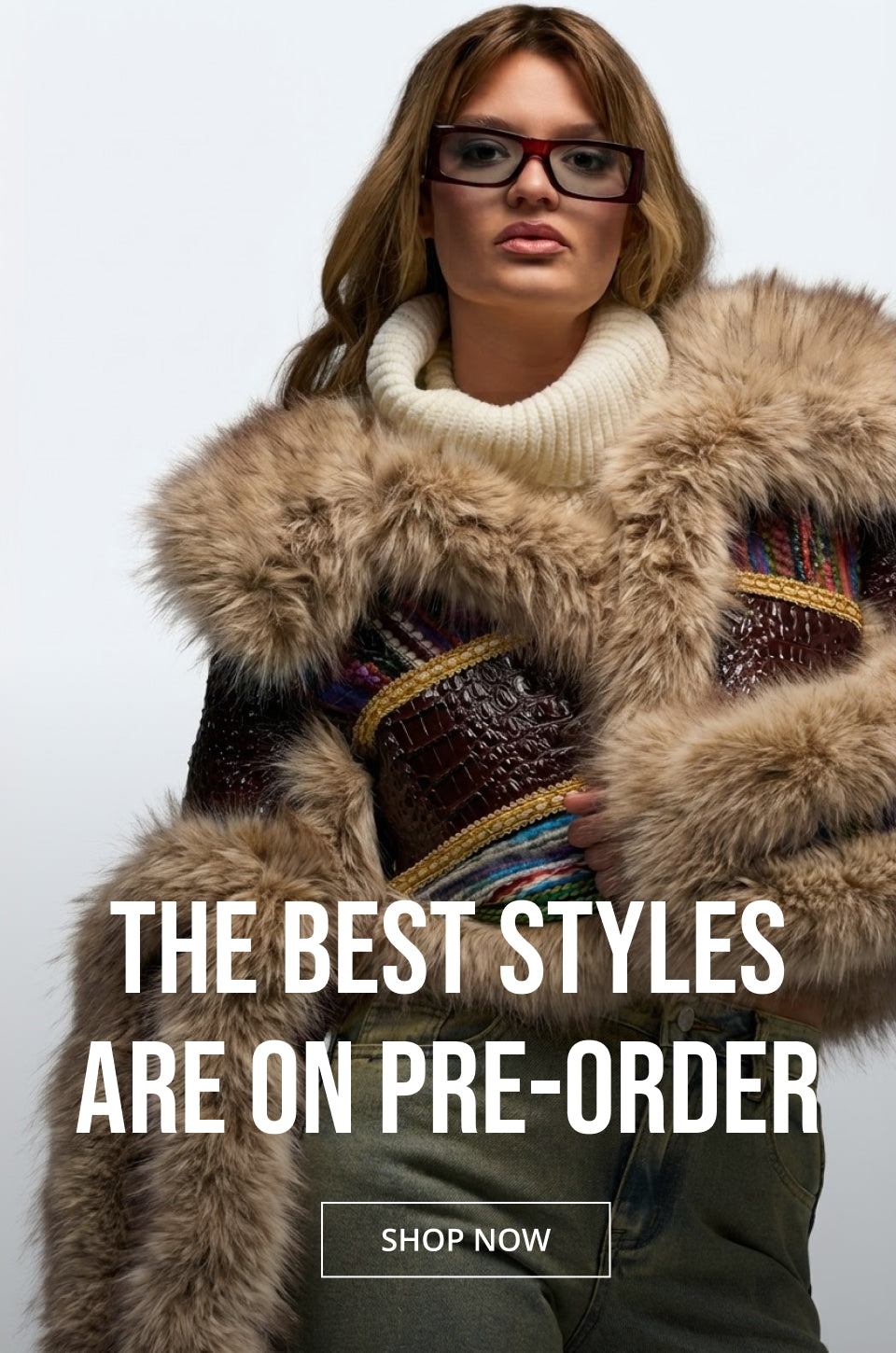 A woman wearing a luxurious brown and beige fur-trimmed jacket over a cream turtleneck sweater and dark pants, set against a plain light gray background. Large white text overlays read 'THE BEST STYLES ARE ON PRE-ORDER' with a 'SHOP NOW' button below.