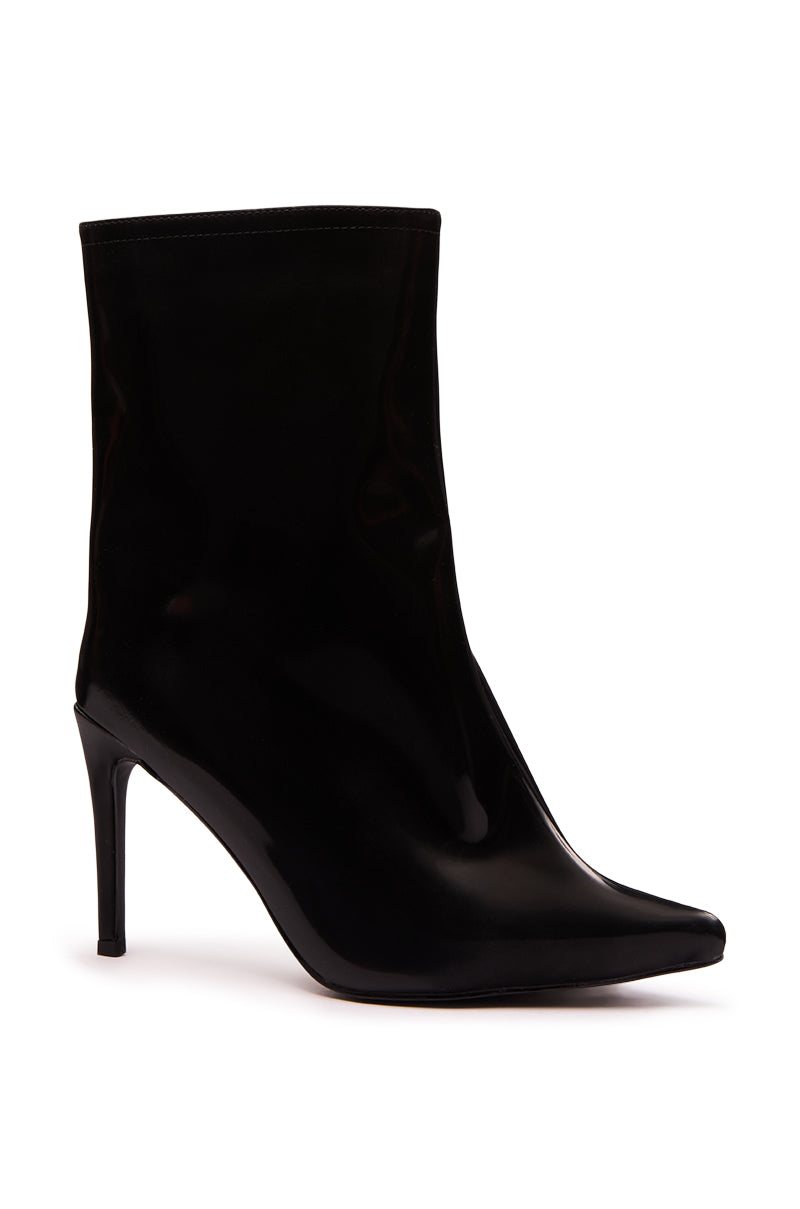 The AZALEA WANG QUINNTA BLACK BOOTIE is an ankle bootie in faux patent leather with a pointed toe and sleek stiletto heel, pictured from the side on a white background.