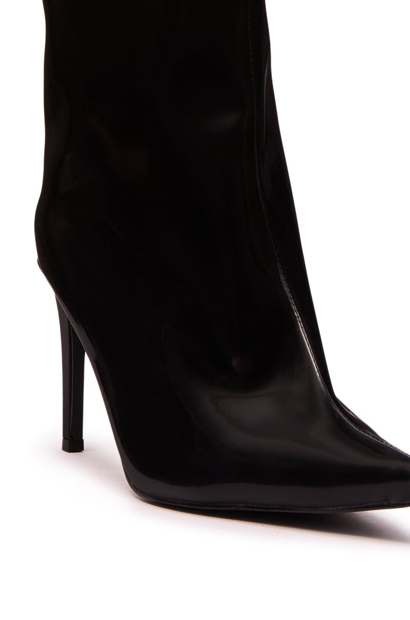 A close-up of the AZALEA WANG QUINNTA BLACK BOOTIE in faux patent leather, showcasing its shiny pointed toe and stiletto heel, set against a white background.