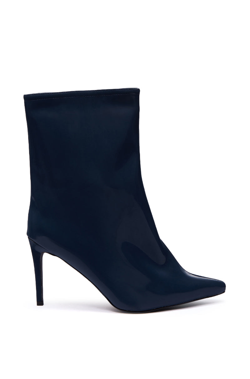 The AZALEA WANG QUINNTA NAVY BOOTIE is a stylish navy ankle boot with a pointed toe and high stiletto heel, made from glossy faux patent leather and shown in profile against a white background.