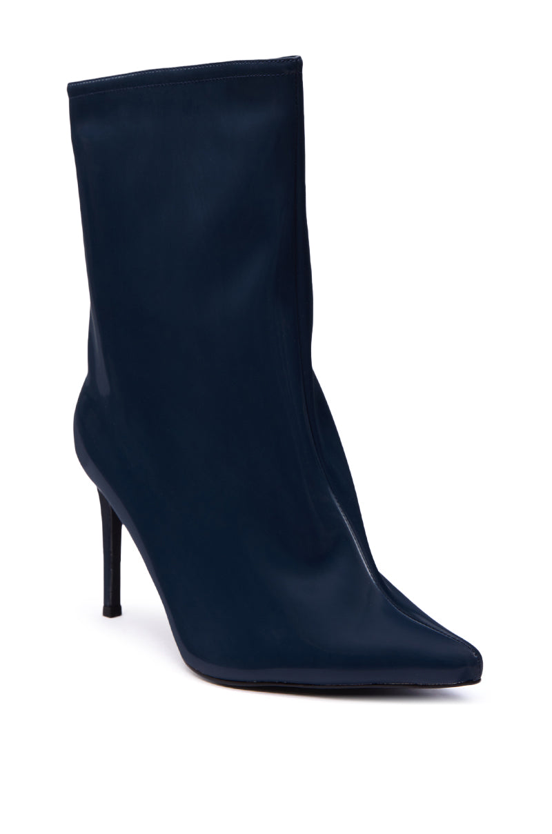 The AZALEA WANG QUINNTA NAVY BOOTIE is a glossy dark navy blue faux patent leather bootie with a pointed toe and slim stiletto heel, shown against a white background.