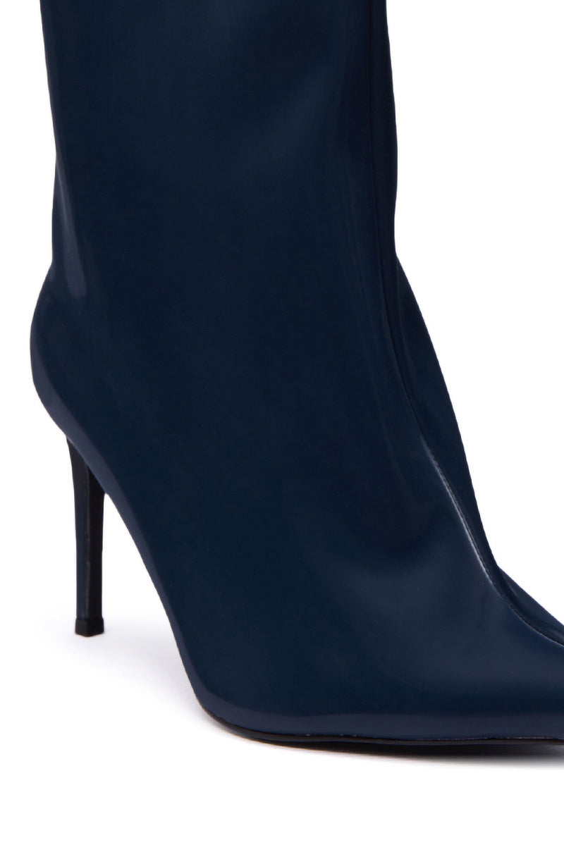 A close-up of the AZALEA WANG QUINNTA NAVY BOOTIE in faux patent leather, showcasing its pointed toe and thin stiletto heel, set against a white background.