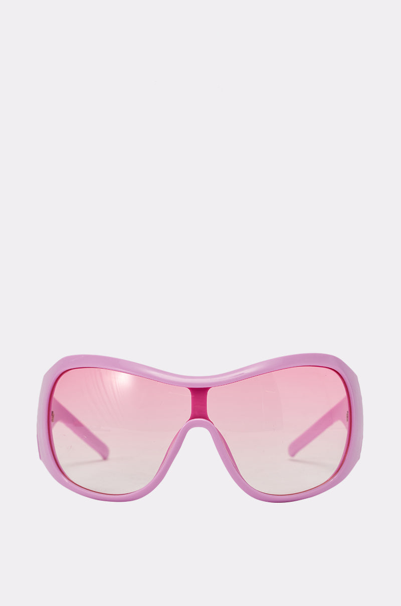 BUBBLEGUM SUNGLASSES feature a bubblegum pink oversized shield frame, displayed front-on against a plain white background—perfect for making a statement at any festival. 2