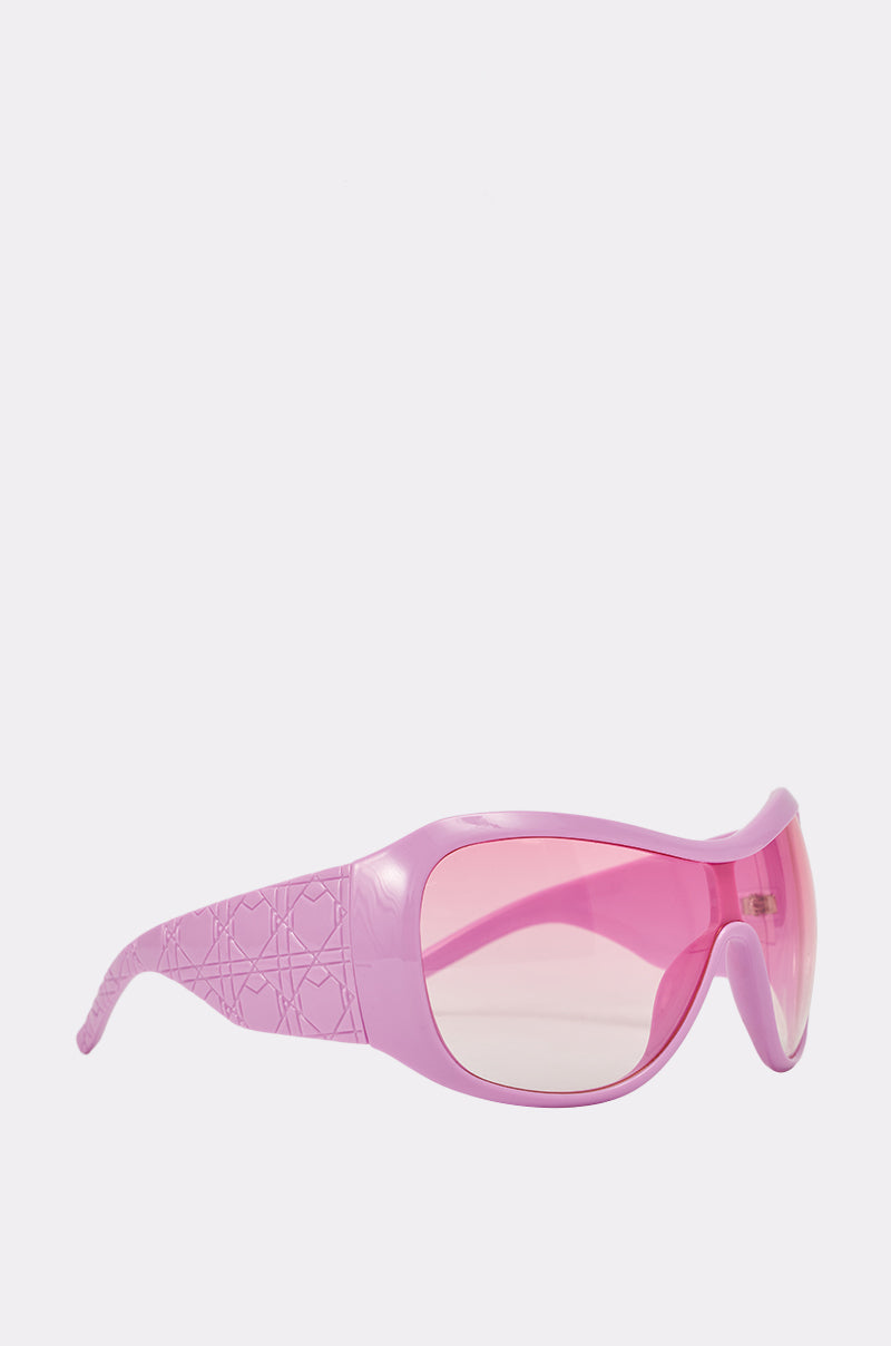 The BUBBLEGUM SUNGLASSES feature a wide, textured oversized bubblegum pink frame with gradient pink-tinted shield lenses, making a bold statement. Shown on a plain white background. 3