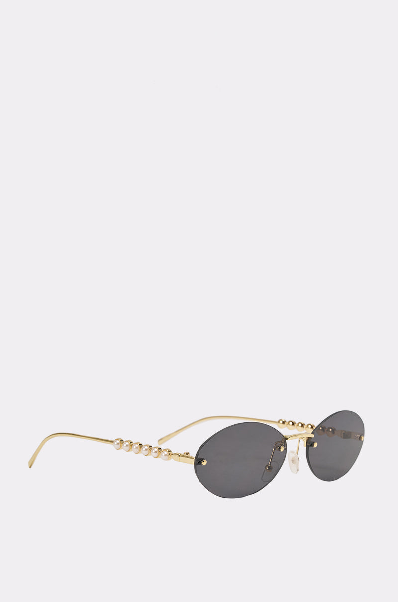 SEE YA SUNGLASSES: Gold-framed mini oval shades with dark lenses and pearl-inspired beads on the arms, shown against a white background for a chic vintage vibe. 0