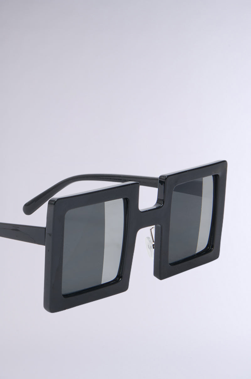 REALLY LIKE THAT SUNGLASSES feature a modern and bold black square frame with square lenses, set against a light gray background.