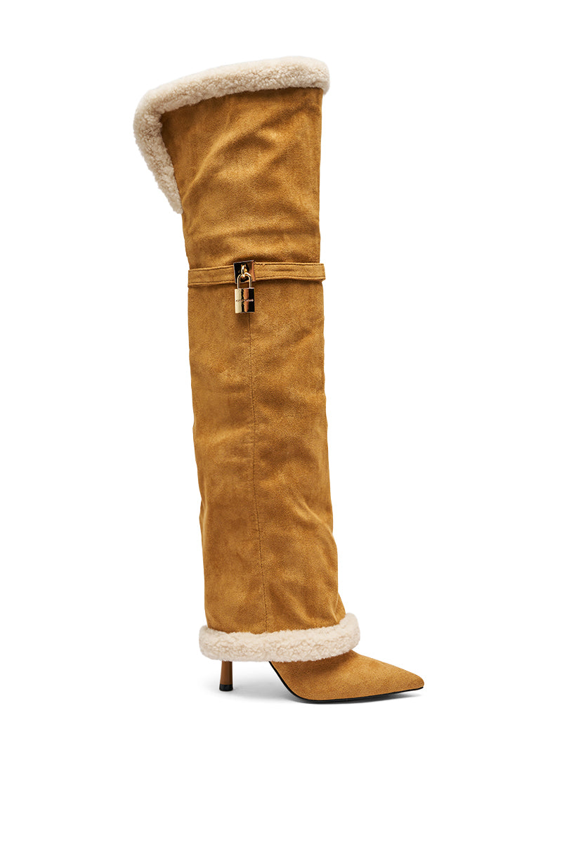 The AZALEA WANG RACHANA TAN SHERPA STILETTO BOOT is a tall, tan faux suede boot with a pointed toe, kitten heel, white shearling trim, gold lock detail, and a slouchy oversized silhouette for chic comfort.
